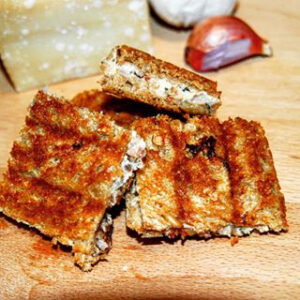 photo of mini grilled ham and cheese sandwiches artistically arranged