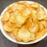 a bowl of golden potato chips