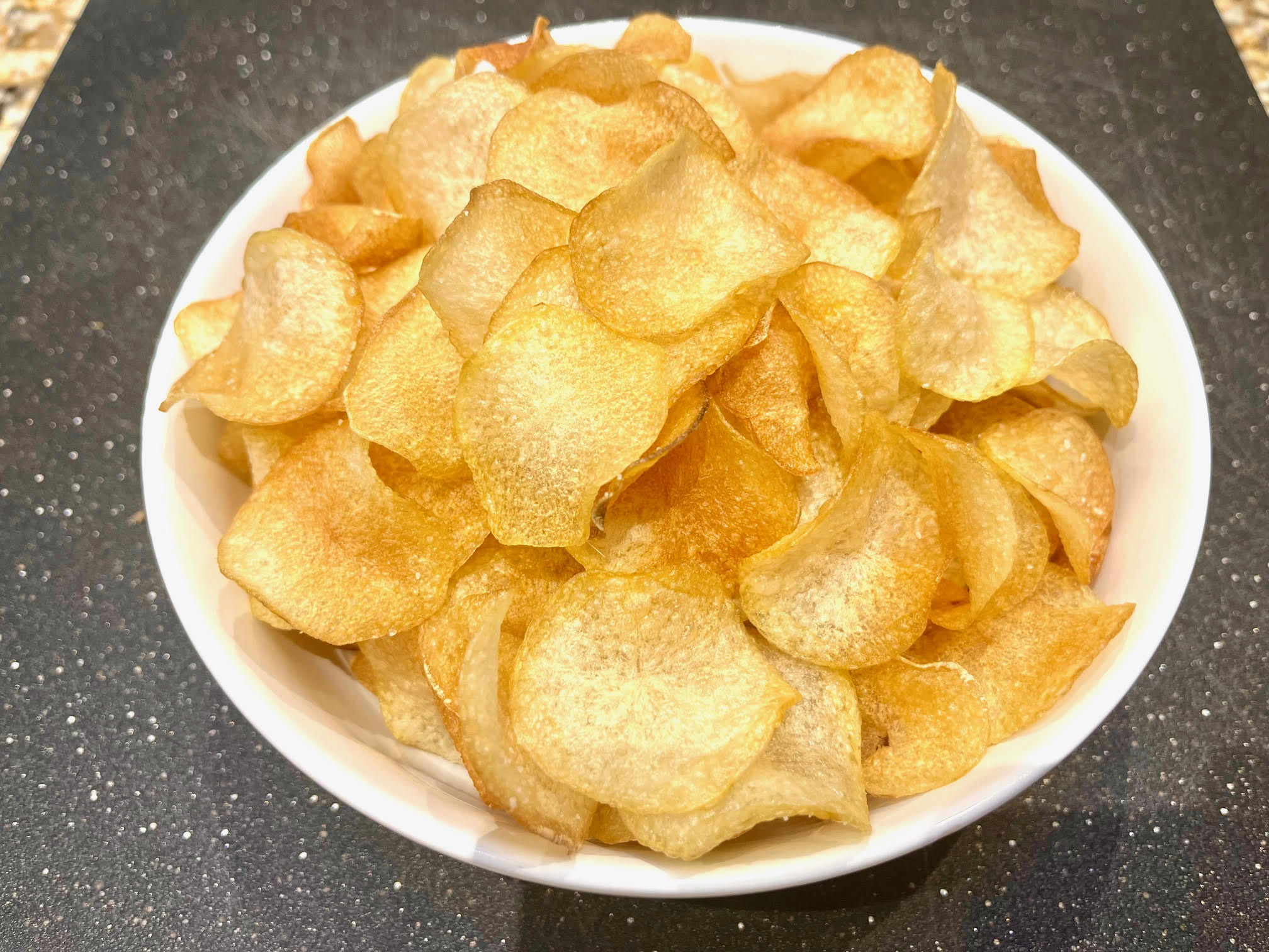 a bowl of golden potato chips