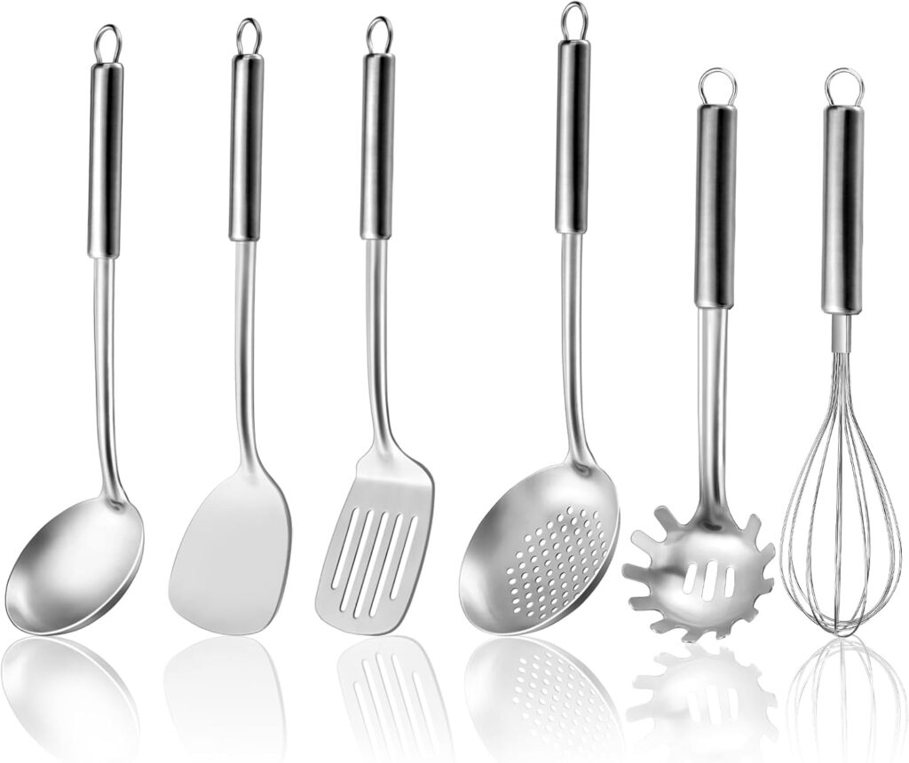 photo of a set of metal kitchen tools, ladle, spatulas, skimmer, whisk, and pasta spoon