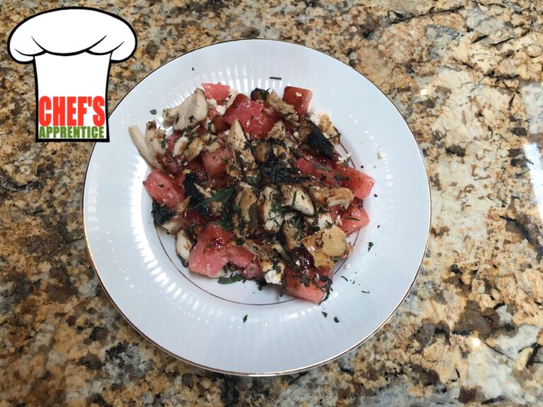 watermelon, chicken, and feta cheese salad in a white bowl