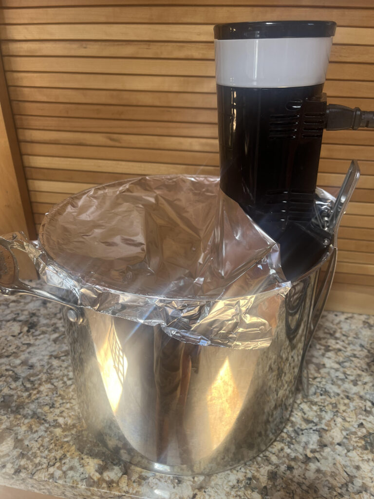 photo of pot with a sous vide device and foil