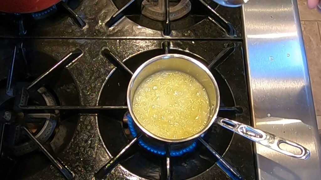 hot melted butter foaming in a saucepan