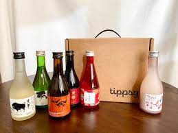 several small sake bottles with a Tippsy Sake branded box