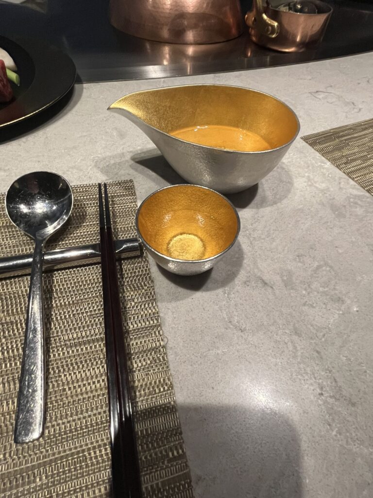 Japanese sake served in a gold-leaf bowl and a gold leaf ochoko cup