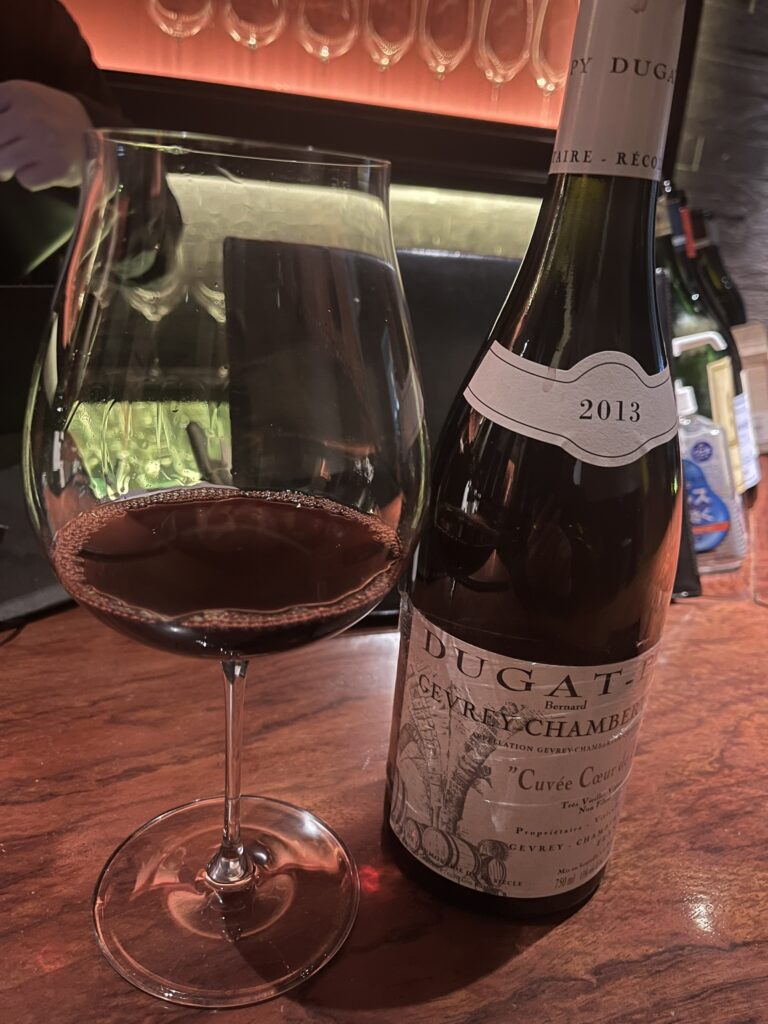 a bottle of Gevrey-Chambertin 2013 red Burgundy French wine and a glass of red wine
