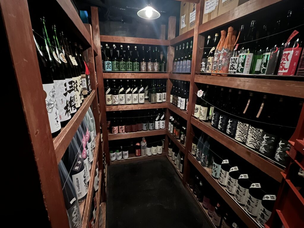 shelves full of sake bottles in the Yamanaka Sake-no-Mise sake shop