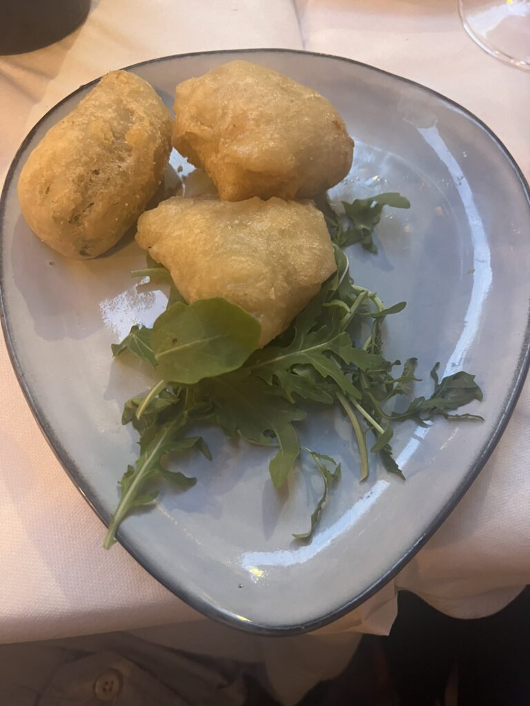 Fried Squash Blossoms with arugula on a grey plate