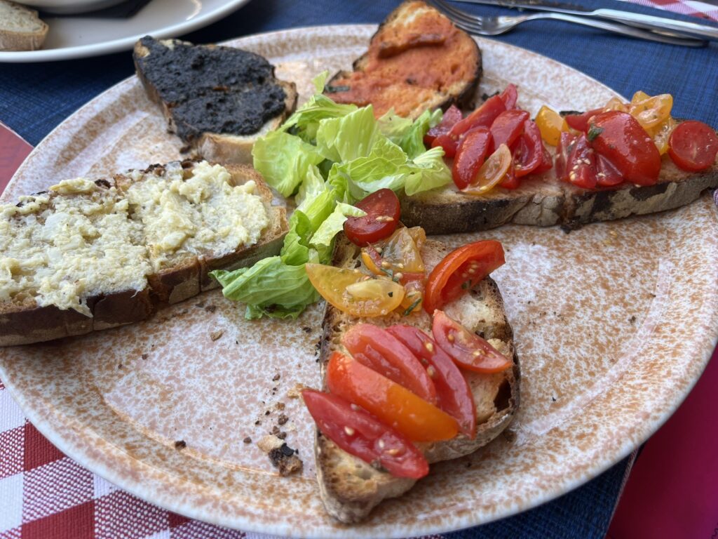 bruschetta combination of tomato, tepanade, and artichoke 