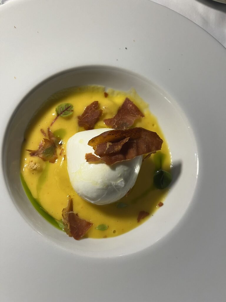 Buffalo Mozzarella, Prosciutto, and Melon Gazpacho in a white bowl