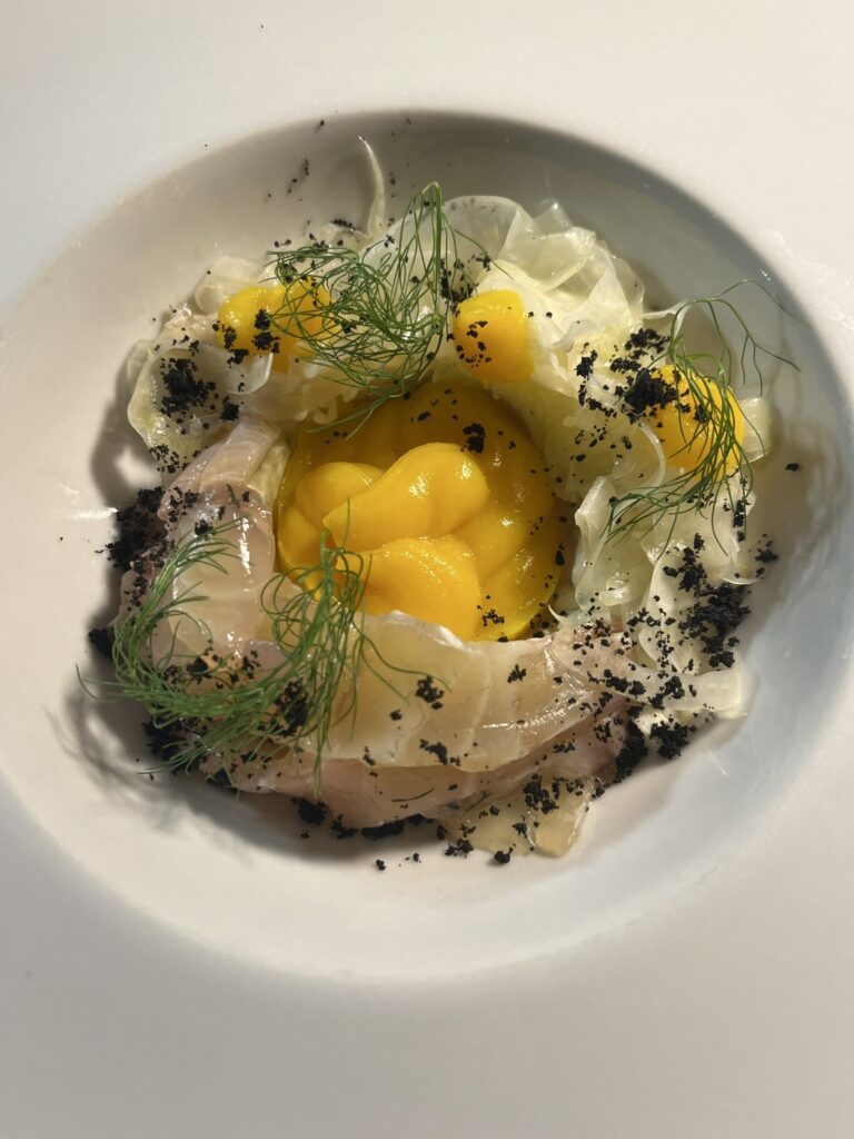 Carpaccio di Pescato fish carpaccio in a white bowl