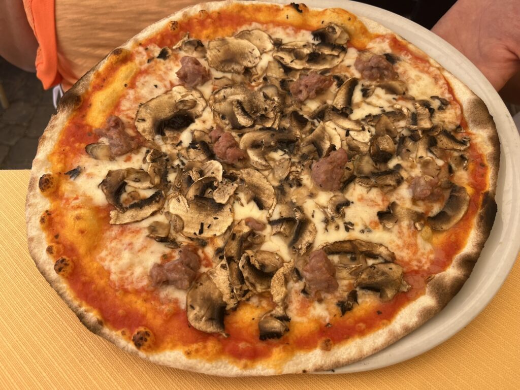 thin-crusted pizza with mushrooms and sausage
