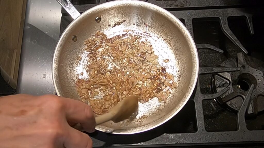 chopped shallots cooking in butter in a saute pan
