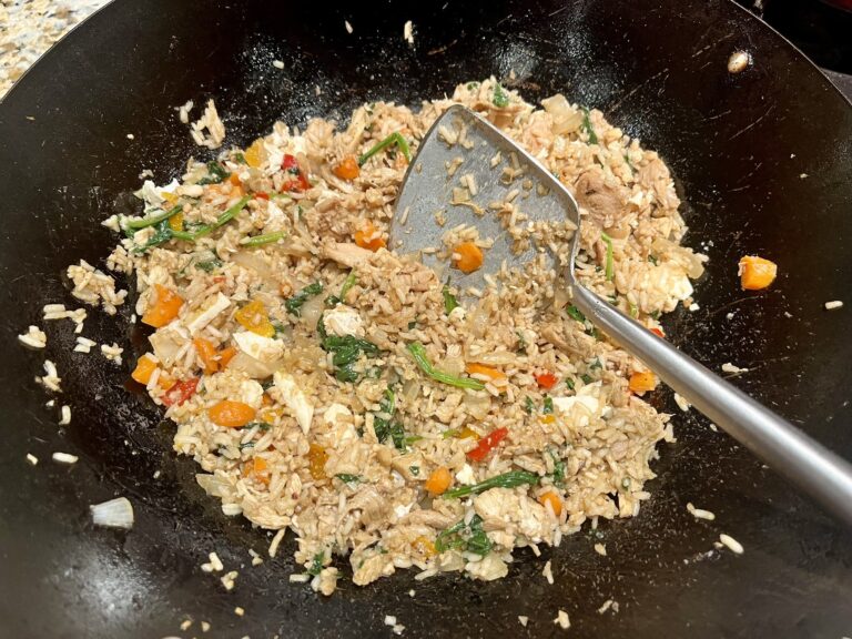 fried rice in a wok with a wok spatula