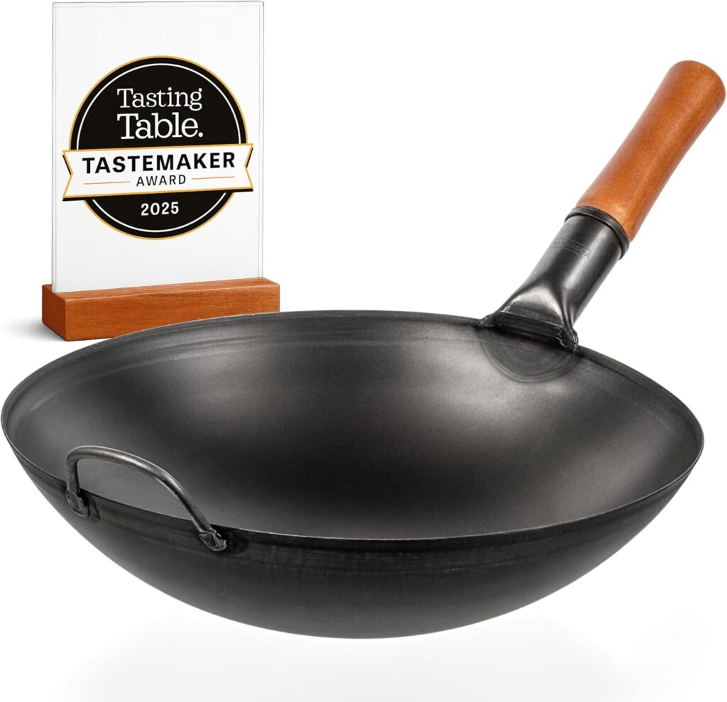 a carbon steel wok with a wooden handle