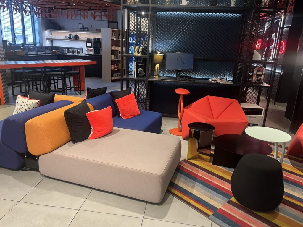 lobby of Aloft hotel in Dijon France with multi-colored seating and other colorful furniture