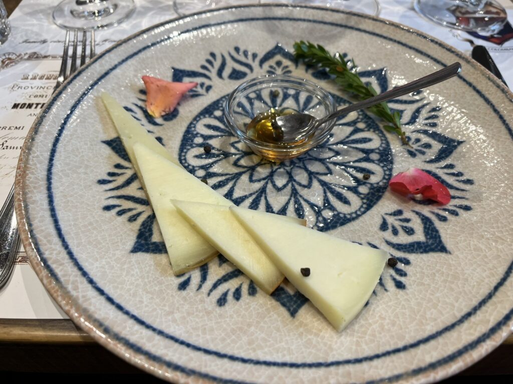 a plate with four slices of cheese with honey
