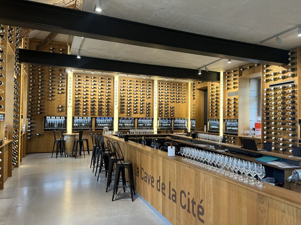a display of wine bottles mounted to walls and wine dispensing machines at La Cave de la Cité in Dijon France