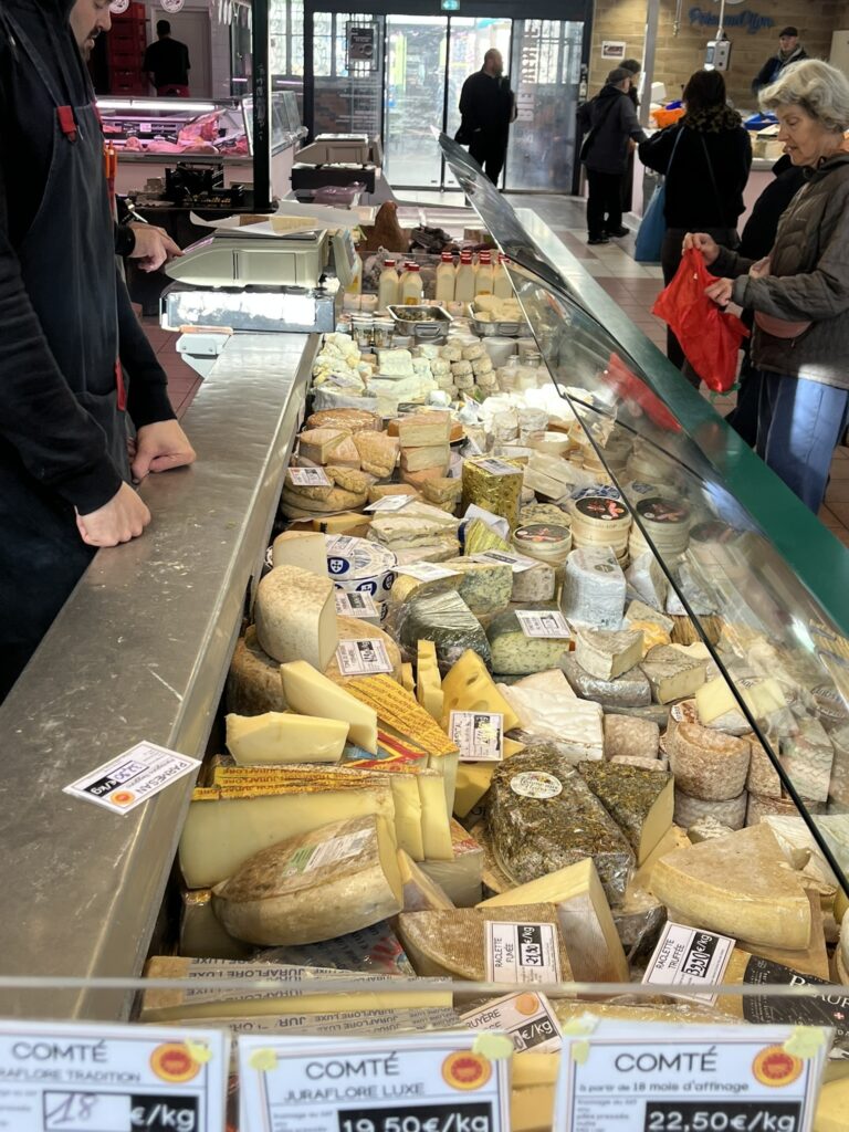 cheesemonger in Les Halles market in Dijon France