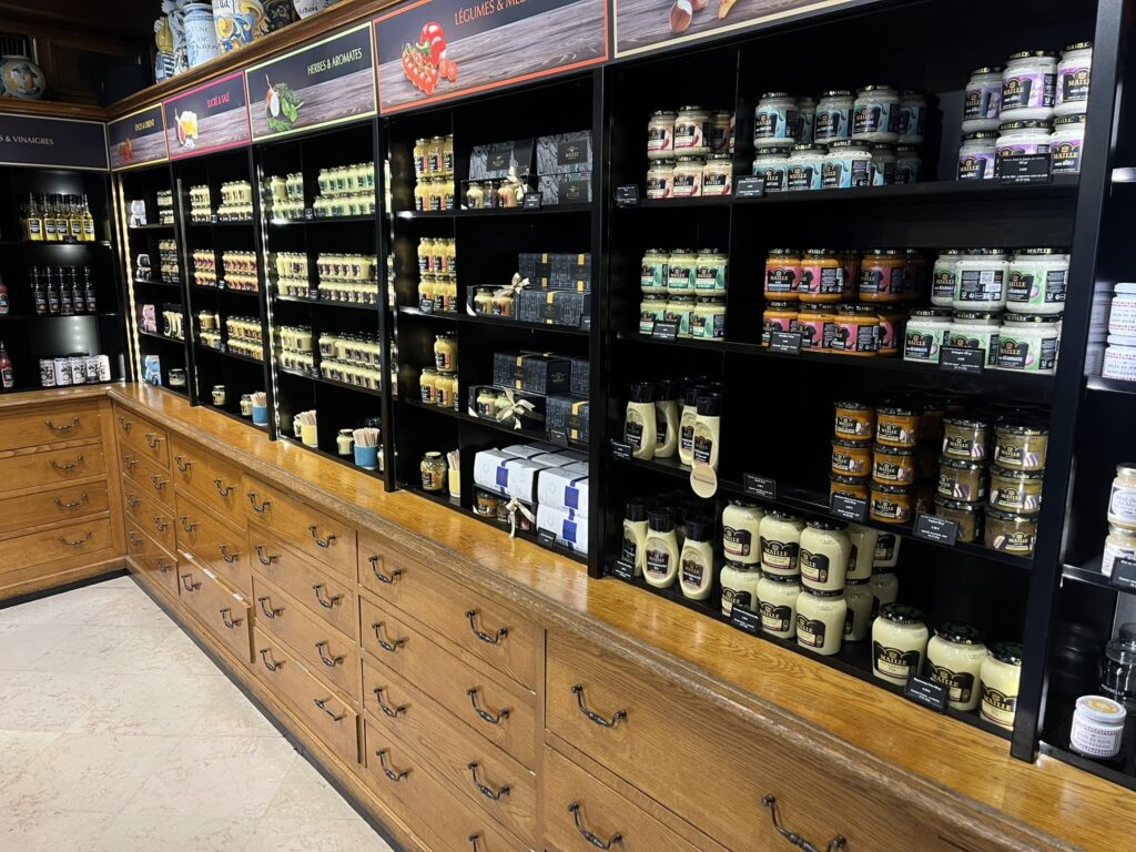 shelves of mustard products in the Moutarde Maille shop in Dijon France