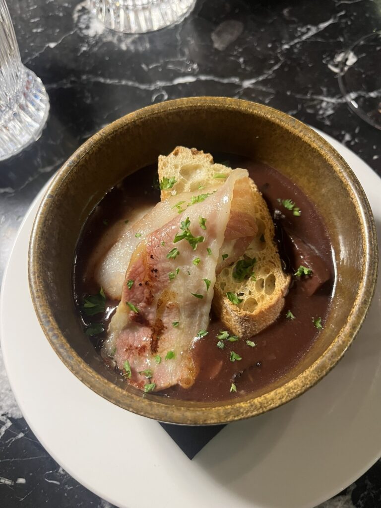 a bowl with Oeuffs Meurette at Speakeasy restaurant in Dijon France
