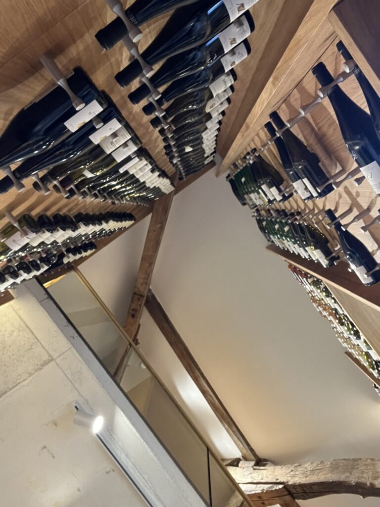 a display of wine bottles mounted to walls at La Cave de la Cité in Dijon France