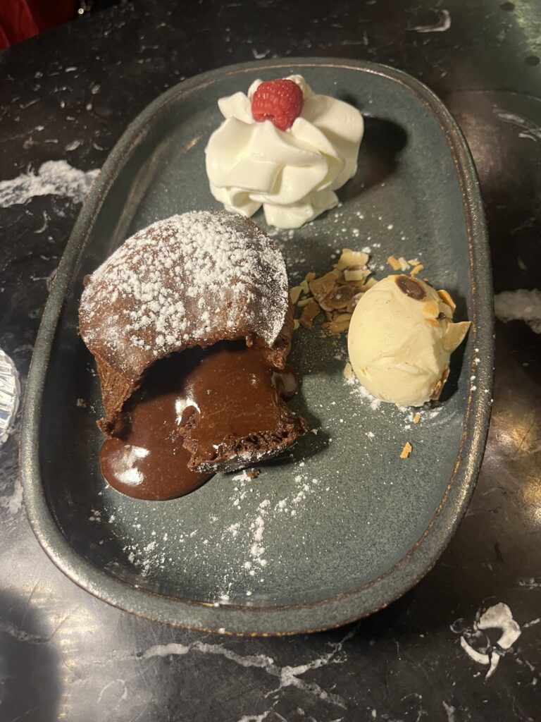 molten chocolate cake with ice cream and whipped cream at Speakeasy restaurant in Dijon France