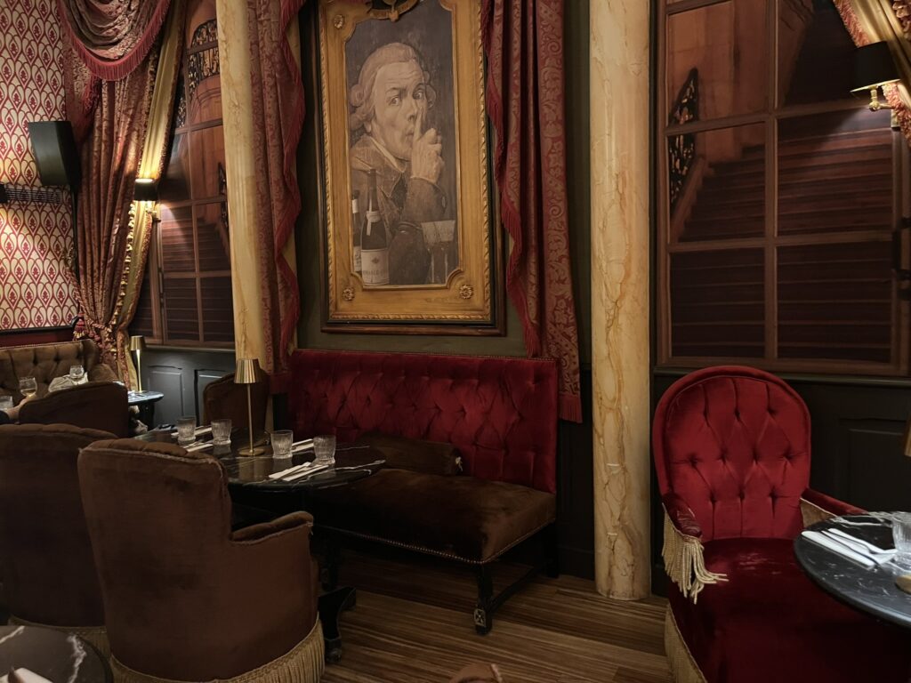 painting of a man making a gesture to be quiet at Speakeasy restaurant in Dijon France