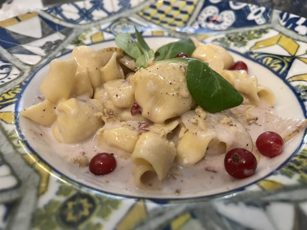 a bowl of little pasta purses (fagotti) stuffed with cheese and pears