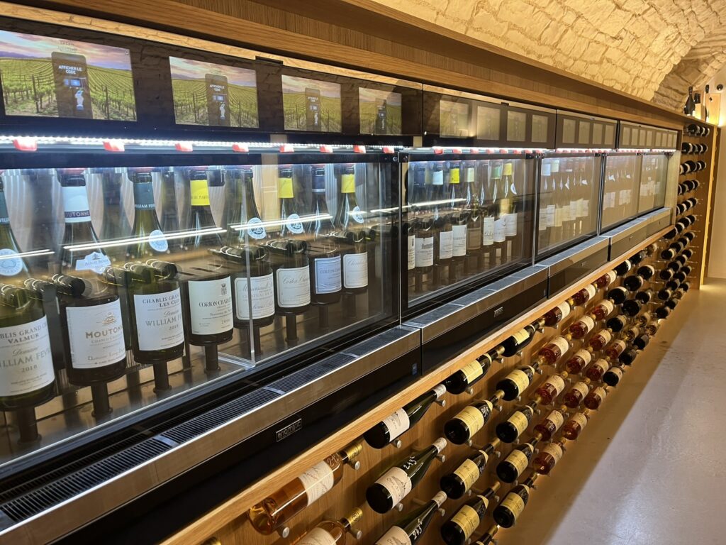 a display of wine bottles mounted to walls and wine dispensing machines at La Cave de la Cité in Dijon France