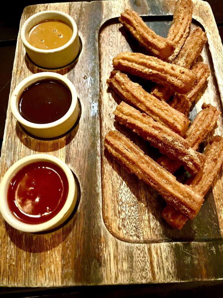 plate of churros with three sauces at Loquita Santa Barbara California