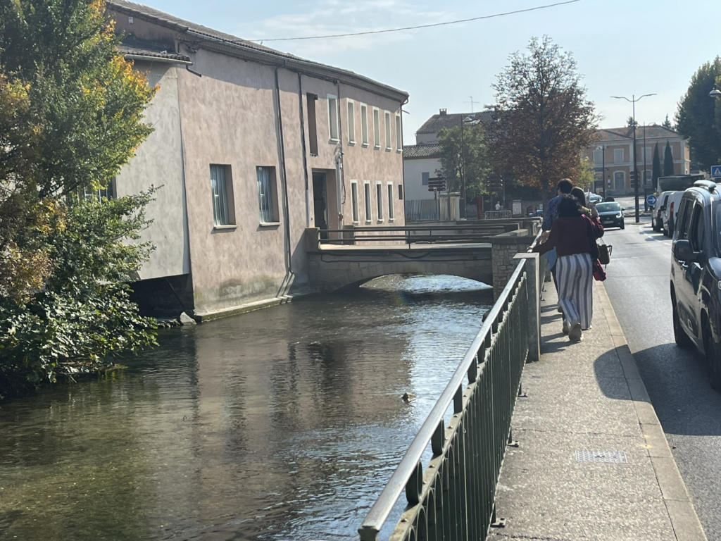 walking along a canal in L'Isle-sur-la-Sorgue, France