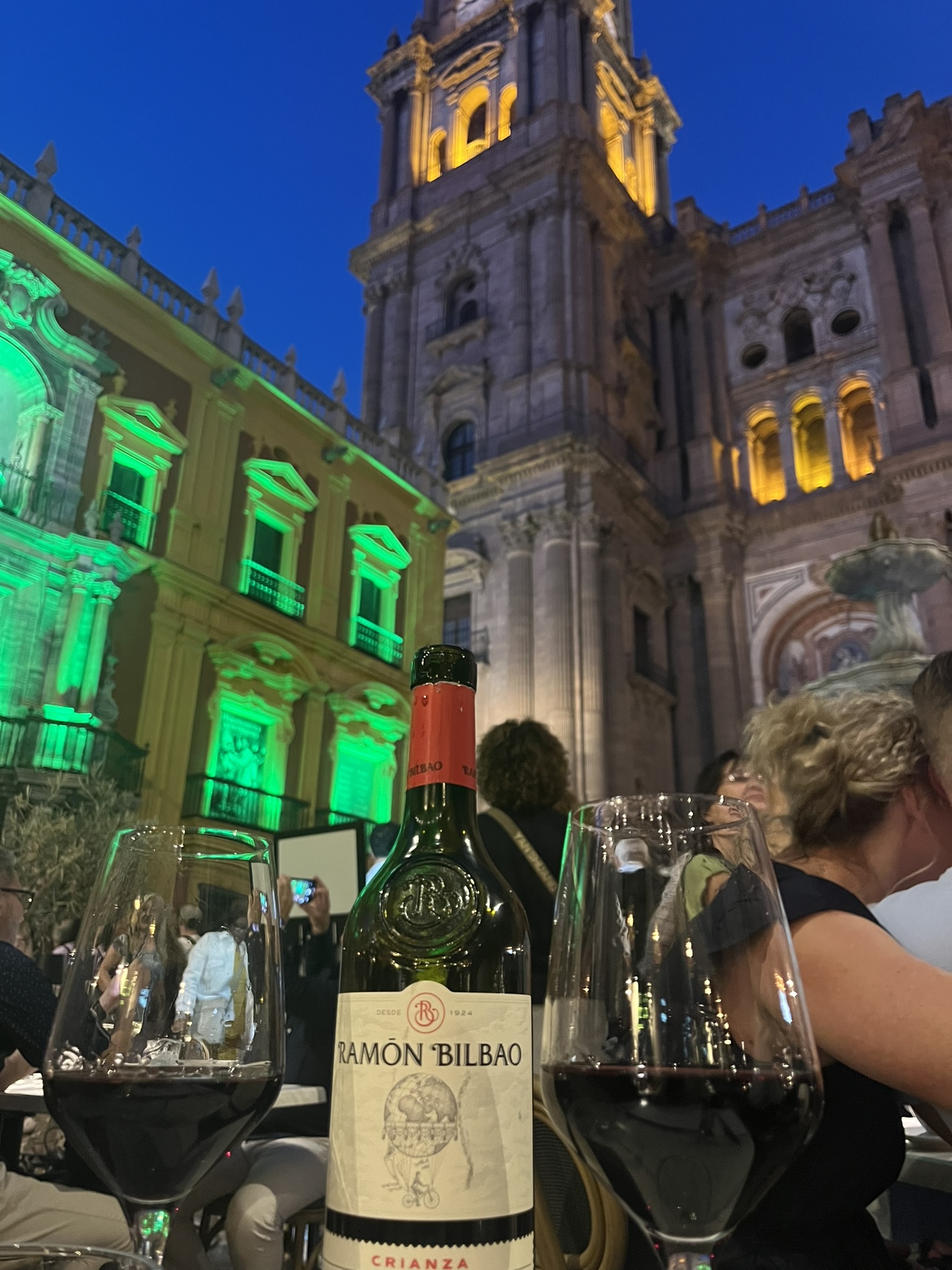 Malaga Spain catherdral Santa Iglesia Catedral Basílica de la Encarnación de Málaga with a bottle of wine and a wine glass in the foreground