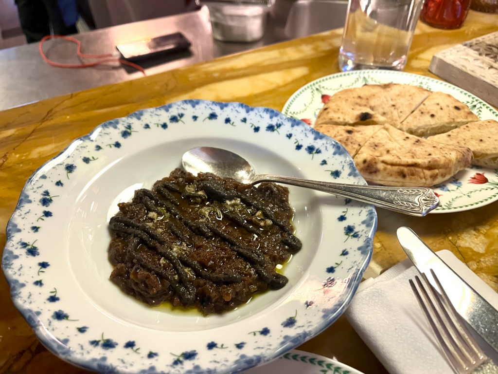 Arayes (pita stuffed with spicy beef), Confit D’Oignons (onion confit with anchovies and black olives) at Boubalé restaurant in Paris France