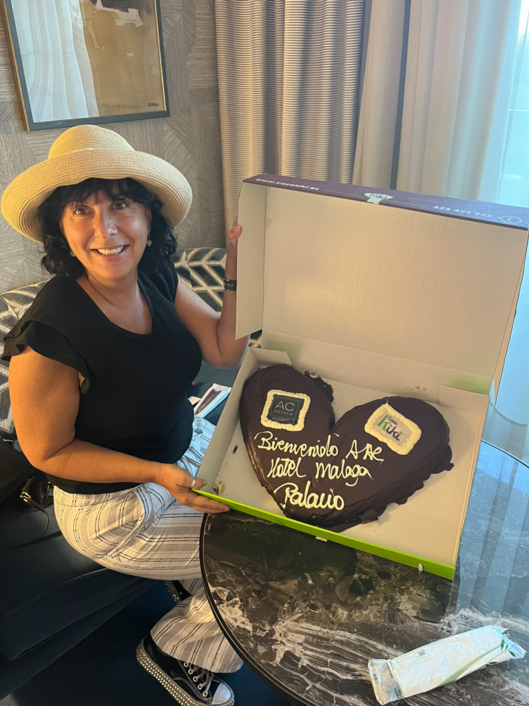 Sarah Alexander with Palmeras (popular chocolate-covered heart-shaped puff pastry) in Malaga Spain