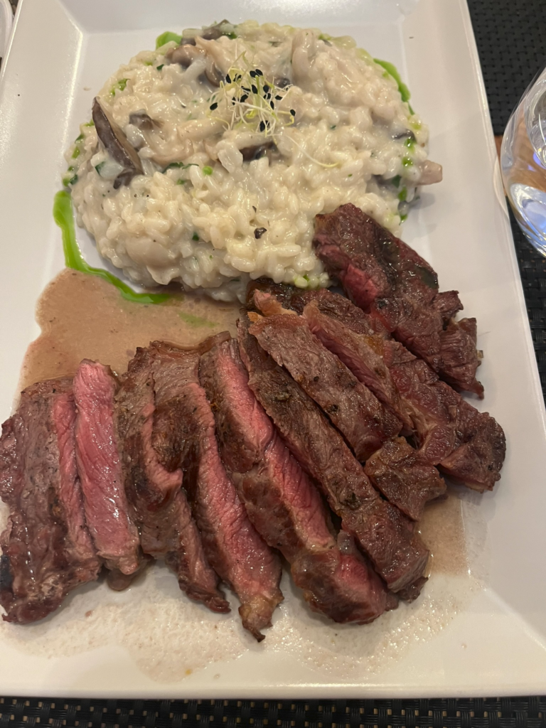 Ribeye steak with mushroom risotto at Ponto Com Sabores Restaurant in Lisbon Portugal